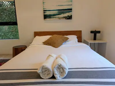 a bedroom with a bed with white towels on it at Luxury suite with private entrance in Los Angeles