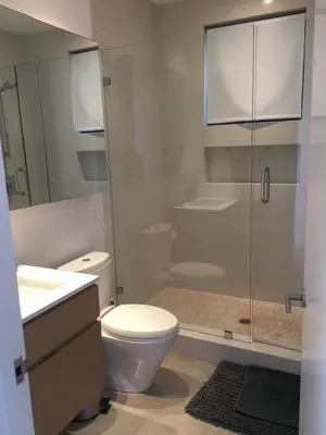 a bathroom with a toilet and a glass shower at Luxury suite with private entrance in Los Angeles