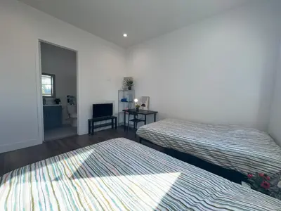 a room with two beds and a television in it at Blue Stay Walk to BMO Stadium and USC in Los Angeles