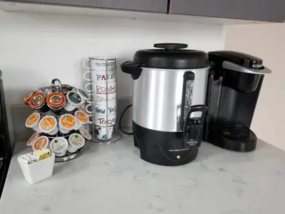 a coffee maker sitting on a counter next to cupcakes at 3 bedroom with Hot Tub and Video game console 10 minutes from Rodeo Drive Beverly Hills in Los Angeles