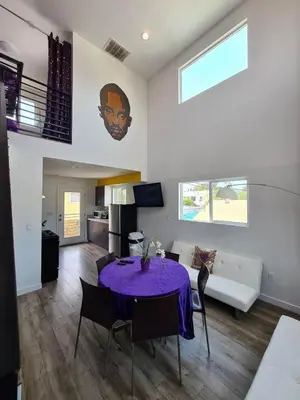a living room with a table and a couch at 3 bedroom with Hot Tub and Video game console 10 minutes from Rodeo Drive Beverly Hills in Los Angeles