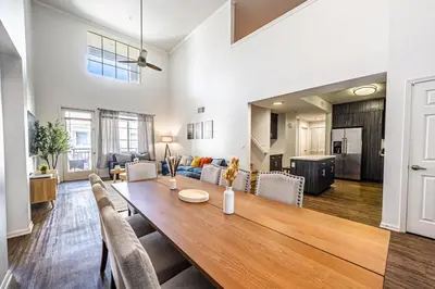 a dining room and living room with a table and chairs at Modern Townhouse with 4 Bedrooms Near LAX in Los Angeles