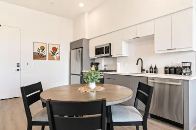 a kitchen and dining room with a table and chairs at Modern Living, Stunning city views, 1Mile to Dodger Stadium in Los Angeles