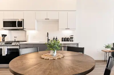 a kitchen with a wooden table with a vase on it at Modern Living, Stunning city views, 1Mile to Dodger Stadium in Los Angeles