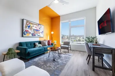 a living room with a couch and a table at Modern Living, Stunning city views, 1Mile to Dodger Stadium in Los Angeles