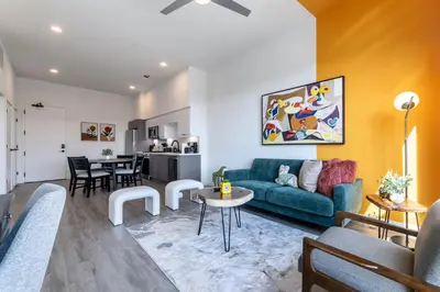 a living room with a couch and a table at Modern Living, Stunning city views, 1Mile to Dodger Stadium in Los Angeles