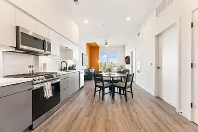 a kitchen with a table and chairs in it at Modern Living, Stunning city views, 1Mile to Dodger Stadium in Los Angeles