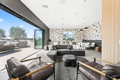 a living room with leather furniture and a large window at The Downtown Haven Suite, 1Mile to Dodger Stadium in Los Angeles