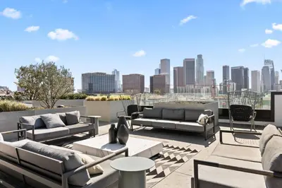 a rooftop patio with couches and a city skyline at The Downtown Haven Suite, 1Mile to Dodger Stadium in Los Angeles
