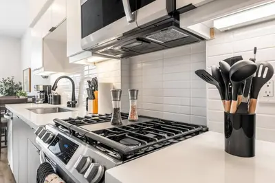 a kitchen with a stove top oven next to a sink at The Downtown Haven Suite, 1Mile to Dodger Stadium in Los Angeles