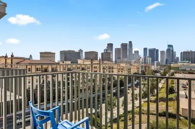 two chairs on a balcony with a view of the city at The Sky loft Suite, DTLA Sunset Views in Los Angeles