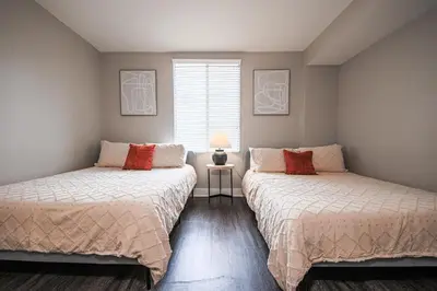 a bedroom with two beds and a window at Sunny 2BDR in SM Pool & Gym - 5 min to the beach! in Los Angeles