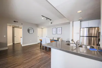 a kitchen and living room with a counter top at Sunny 2BDR in SM Pool & Gym - 5 min to the beach! in Los Angeles