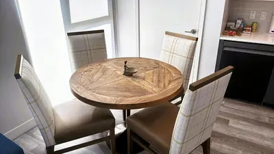 a wooden dining room table with two chairs and a table and chairsuggest at Melrose Luxe Retreat near The Grove in Los Angeles