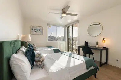 a bedroom with two beds and a desk at Jade Breeze - Elegant 2BR near Water Outstanding Amenities in Los Angeles