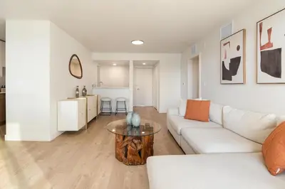 a living room with a white couch and a table at Jade Breeze - Elegant 2BR near Water Outstanding Amenities in Los Angeles