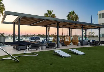 a pavilion with chairs and hammocks on a lawn at Jade Breeze - Elegant 2BR near Water Outstanding Amenities in Los Angeles