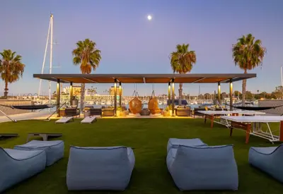 a large pavilion with chairs and tables on the grass at Jade Breeze - Elegant 2BR near Water Outstanding Amenities in Los Angeles