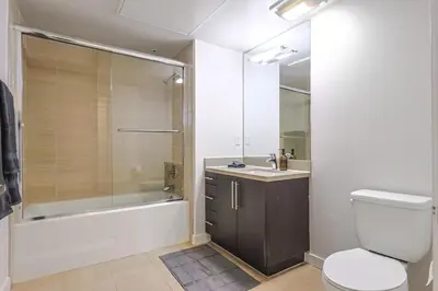 a bathroom with a toilet and a sink and a shower at 2BR Condo in Santa Monica - Walking Distance to Beach, Dining, Shopping & Promenade in Los Angeles