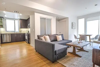 a living room with a couch and a table at 2BR Condo in Santa Monica - Walking Distance to Beach, Dining, Shopping & Promenade in Los Angeles