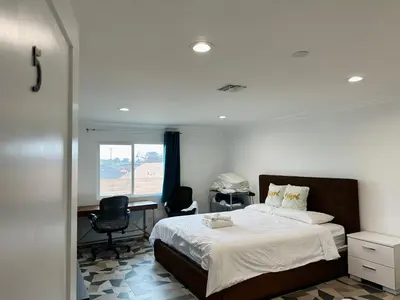 a bedroom with a bed and a desk and a window at Luxe Stay Room with Private Bathroom 55 in Los Angeles