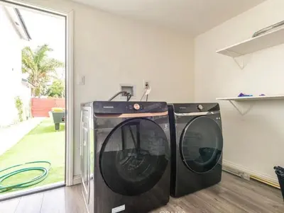 two washing machines sitting in a laundry room at Luxe Stay Room with Private Bathroom 55 in Los Angeles