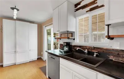 a kitchen with a sink and a counter top at Western style pool home, 4 bedroom and large yard in Apple Valley