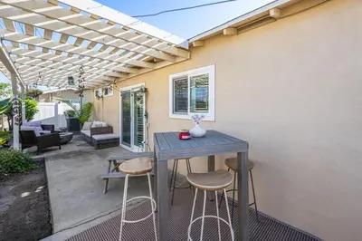 a patio with a blue table and stools at The 3BR-2BA Extended Stay Oasis in Anaheim in Anaheim