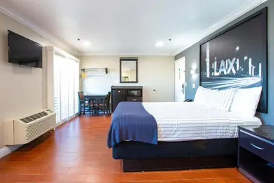 a hotel room with a bed and a television at Elev8 Hotel Los Angeles, LAX in Inglewood
