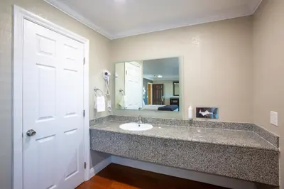 a bathroom with a sink and a mirror at Elev8 Hotel Los Angeles, LAX in Inglewood