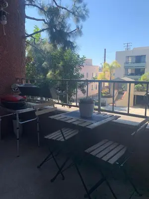 a table and chairs sitting on top of a balcony at Sunny Retro Row Condo- Walk to Beach! in Long Beach