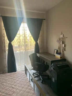 a bedroom with a desk and a chair next to a window at Sunny Retro Row Condo- Walk to Beach! in Long Beach
