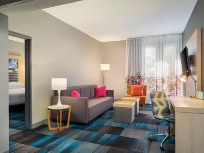 a living room with a couch and a chair at Aloft El Segundo - Los Angeles Airport in El Segundo