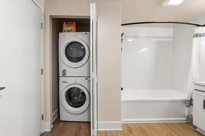 a laundry room with a washer and dryer at Spinel Stay - Charming 2BR Retreat Zen Garden Views Central in Los Angeles