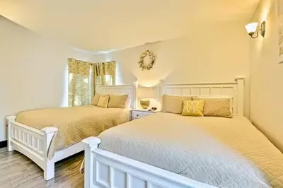 two beds in a bedroom with white walls at Peaceful Retreat in Anaheim-close to Disney in Anaheim