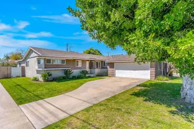 a house with a driveway and a tree at Anaheim Dream Haven-disneyland Pool Foosball in Anaheim