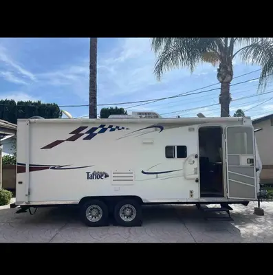 a white trailer parked in front of a house at Cozy private couples camper in San Gabriel CA in San Gabriel