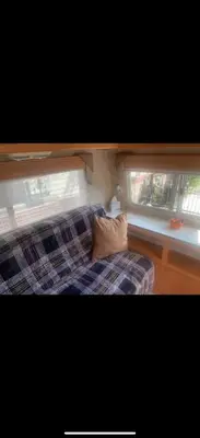 a bedroom with a couch and a window at Cozy private couples camper in San Gabriel CA in San Gabriel