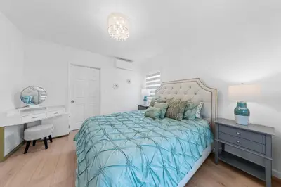 a bedroom with a bed with a desk and a bed sidx sidx sidx at Cozy 3BR in San Gabriel in San Gabriel
