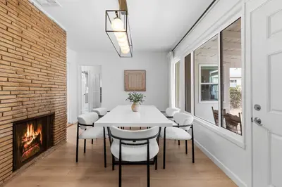 a dining room with a fireplace and a white table and chairs at Cozy 3BR in San Gabriel in San Gabriel