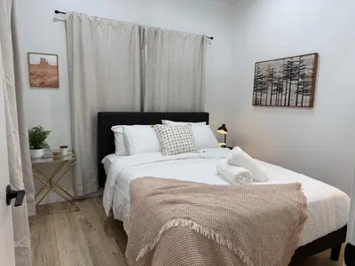 a bedroom with a large bed with white sheets at Comfy & calm rooms near I-10, Temple city in Temple City