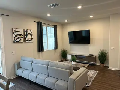 a living room with a couch and a flat screen tv at Gated Upland Home 3b 3 bath in Upland