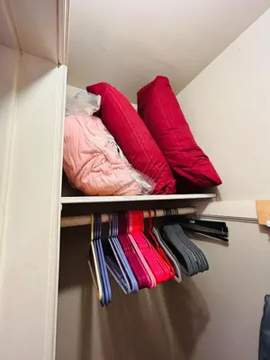 a closet with red and pink pillows on shelves at UNIQUE SPANISH HACIENDA HOUSE with POOL VINTAGE 1948 EUROPEAN ANTIQUES ETHNIC ART in Bakersfield