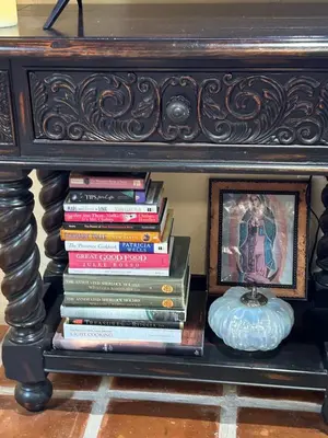 a table with a stack of books on a shelf at UNIQUE SPANISH HACIENDA HOUSE with POOL VINTAGE 1948 EUROPEAN ANTIQUES ETHNIC ART in Bakersfield