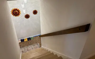 a bathroom with a shower with a sunflower on the wall at Warm nest Rancho Cucamonga in Rancho Cucamonga