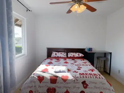 a bedroom with a bed and a ceiling fan at Warm nest Rancho Cucamonga in Rancho Cucamonga