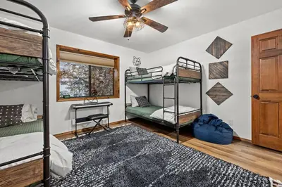 a bedroom with bunk beds and a ceiling fan at Nest and Needles in Big Bear Lake