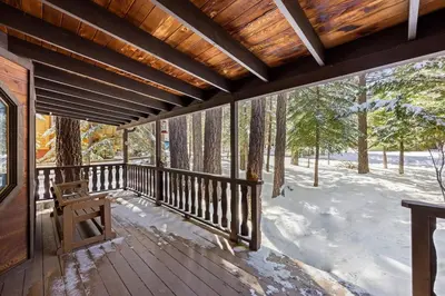 a porch of a cabin with snow on the ground at Nest and Needles in Big Bear Lake