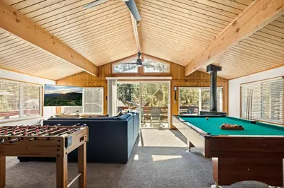 a room with a pool table and two billards at Wild Heart Cabin in Big Bear Lake