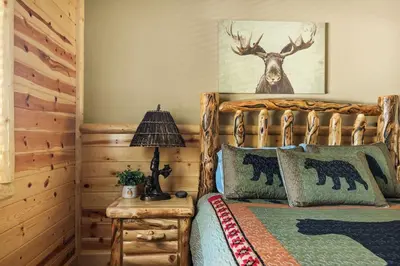 a bedroom with a bed with a deer head on the wall at High Altitude Retreat in Big Bear Lake